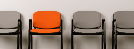 Three grey chairs and one orange chair