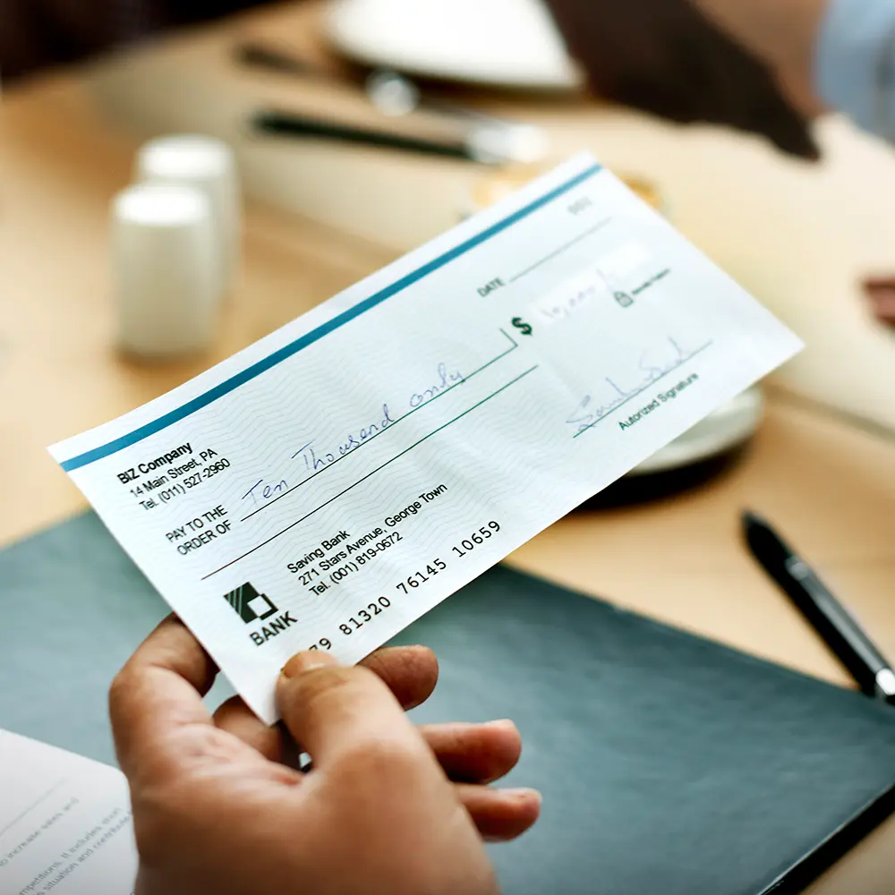 Person choosing acoustic guitar in store.