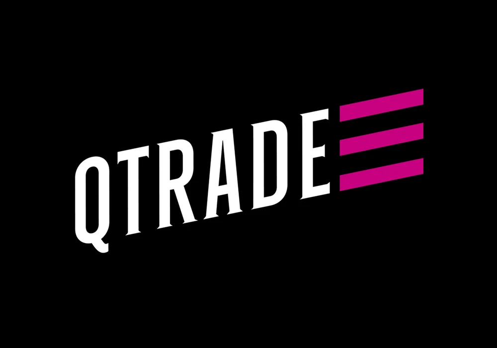 Older man sits on a sofa talking on the phone and using a laptop