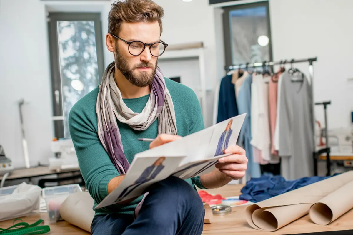 Student smiling in hallway holding backpack straps
