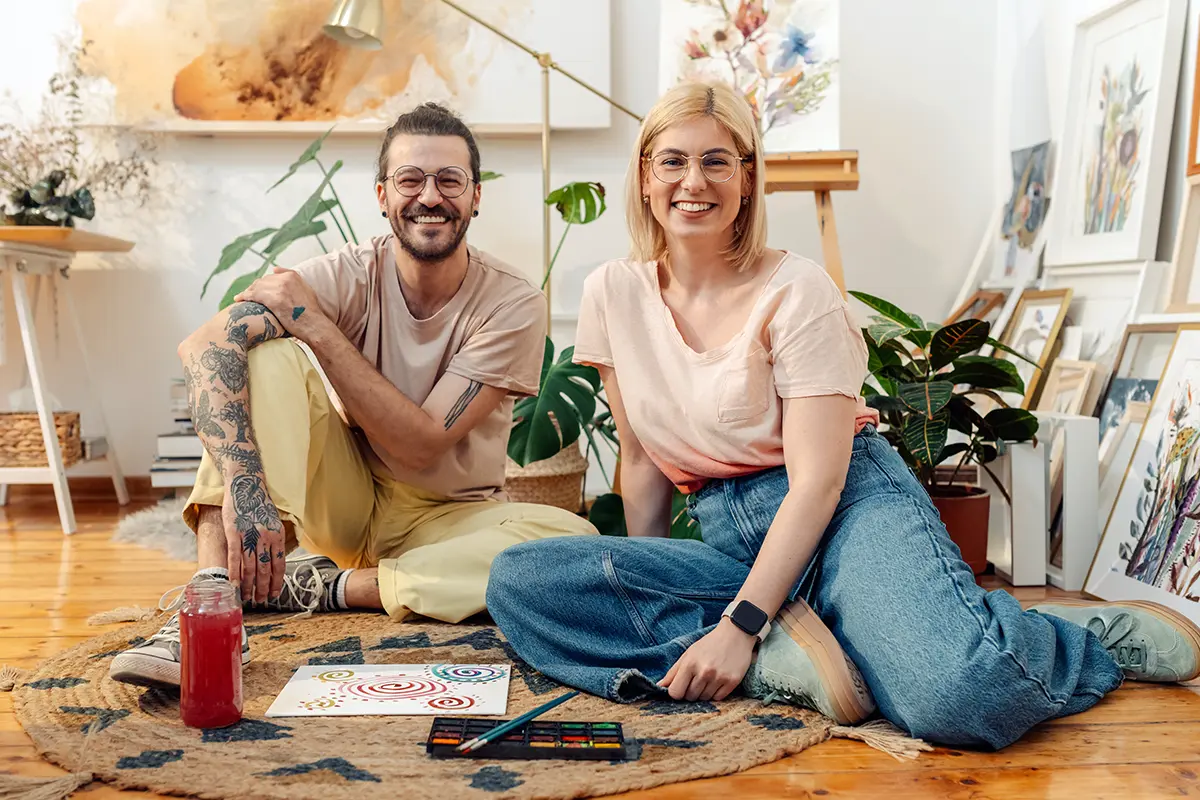 Couple sitting on a rug.