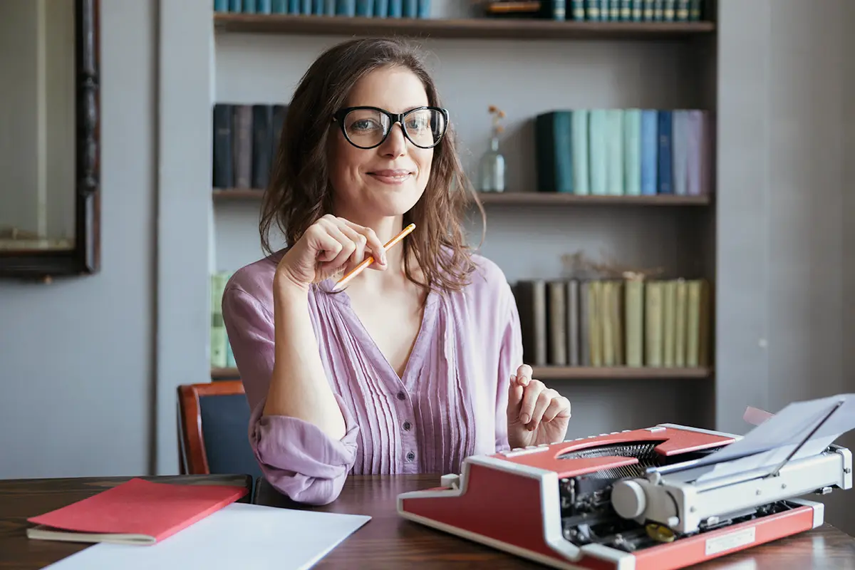 A hand holding a debit card above a payment terminal for a contactless transaction