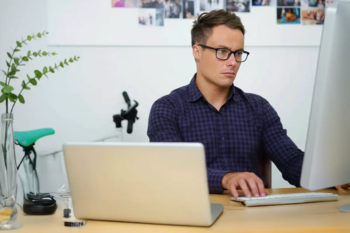 Artist painting outdoors on easel.