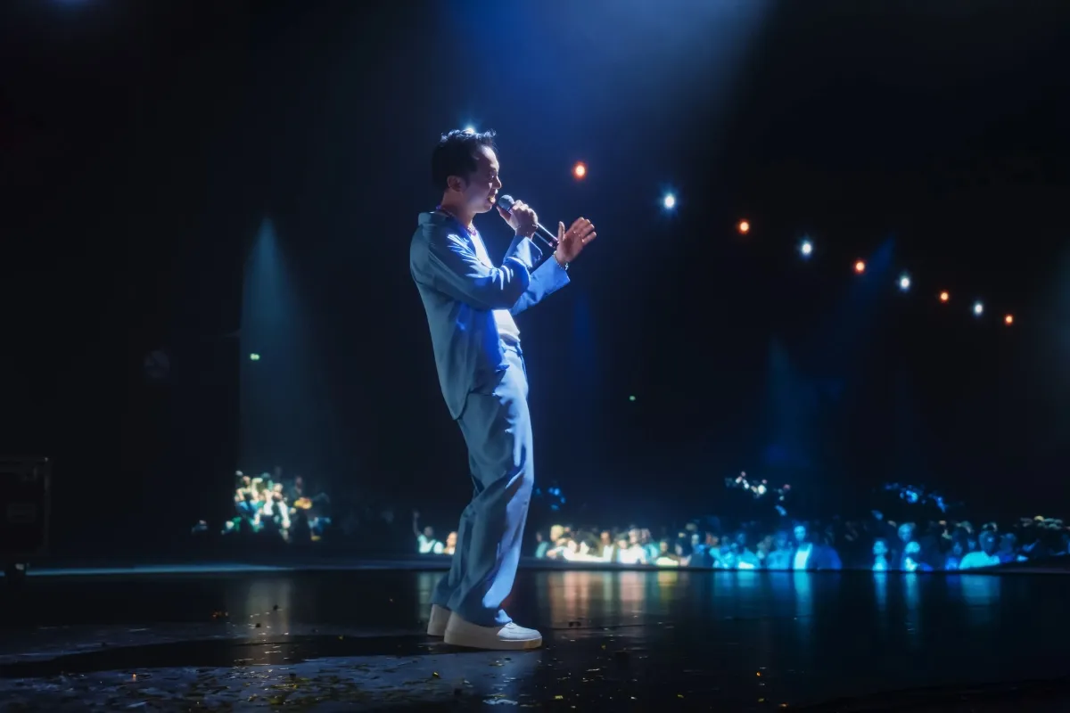 Independent performer on stage in front of a live audience, symbolizing borrowing for freelancers who rely on flexible financial solutions from Creative Arts Financial. 