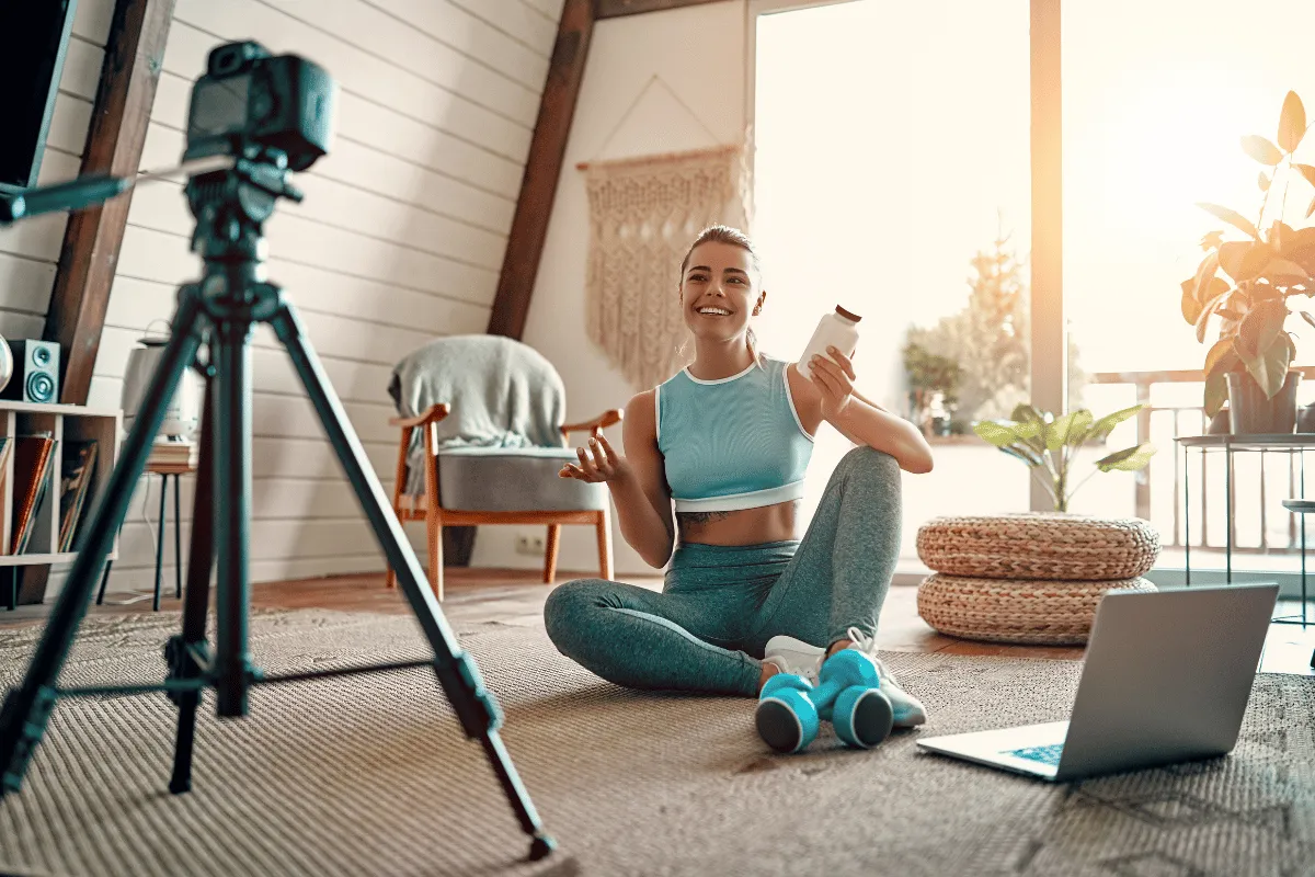Wellness creator filming content at home, representing income planning and financial management for self‑employed creatives.