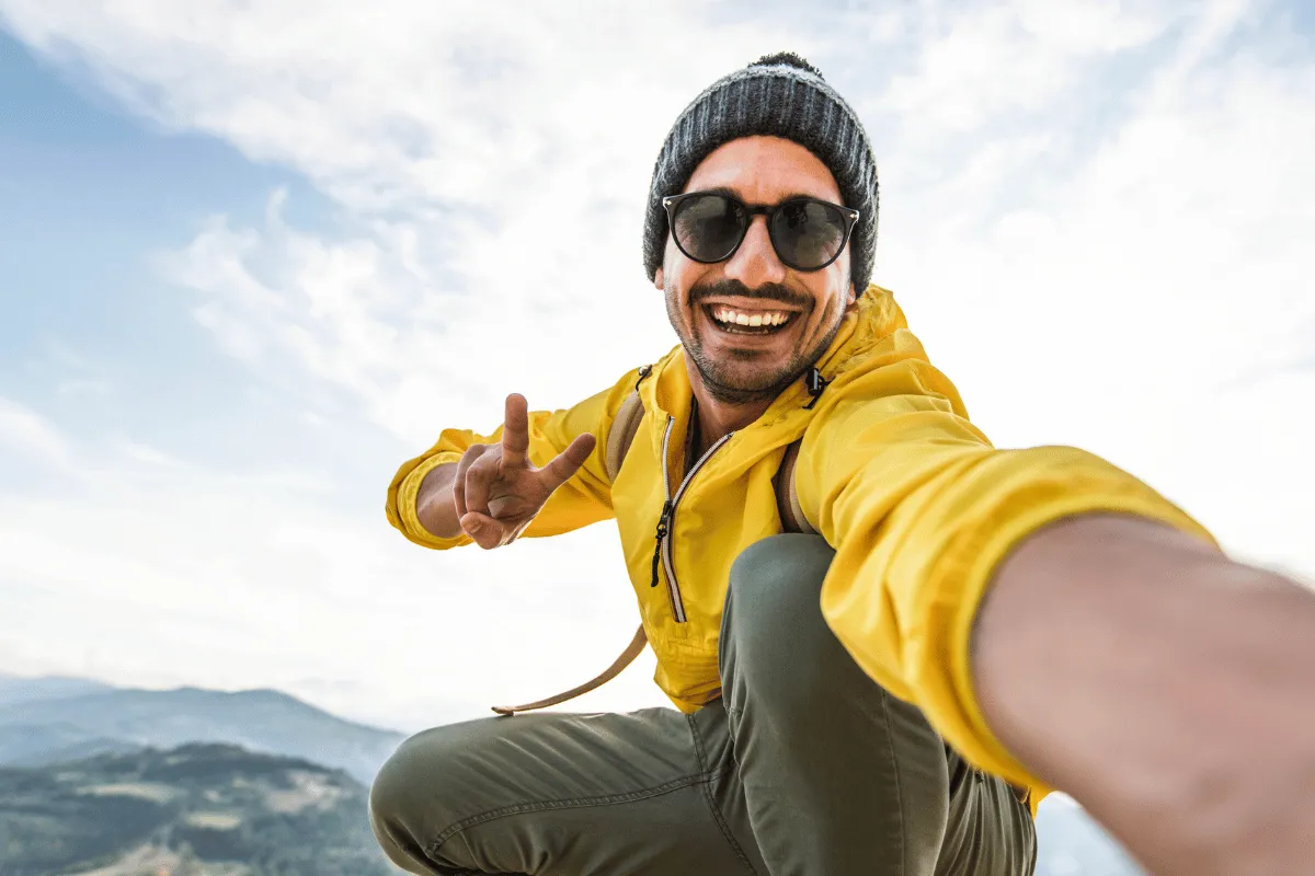 Lifestyle creator taking a selfie outdoors, symbolizing financial freedom through smart money management for creatives.