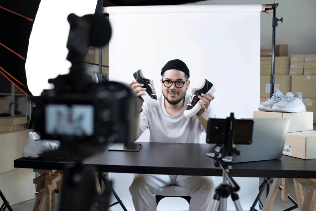 Creator filming product content in a studio, representing financial planning and income management for creative entrepreneurs.