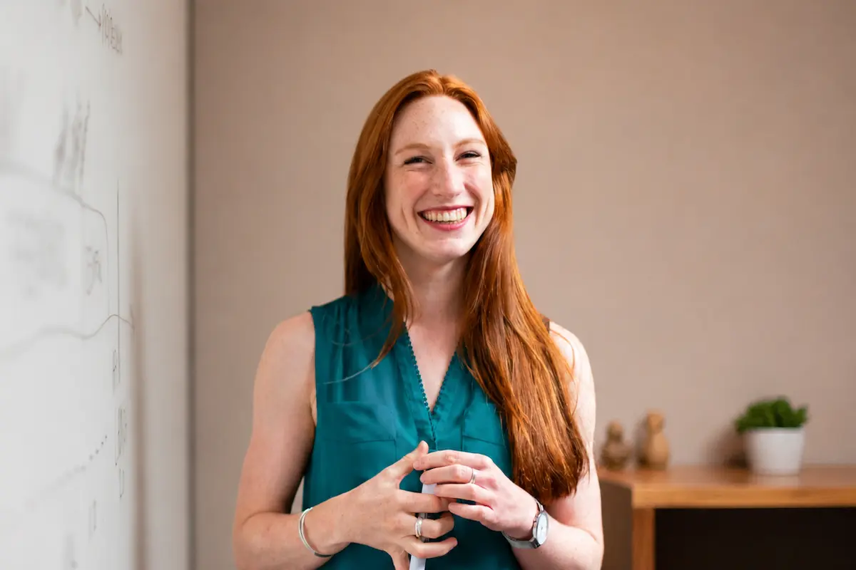 Smiling woman leading a financial literacy workshop.