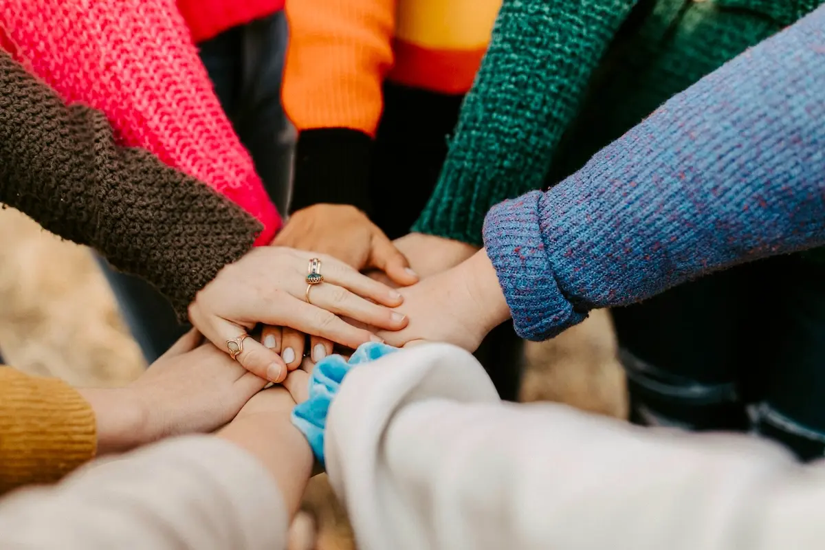 Volunteers joining hands in support of the community.