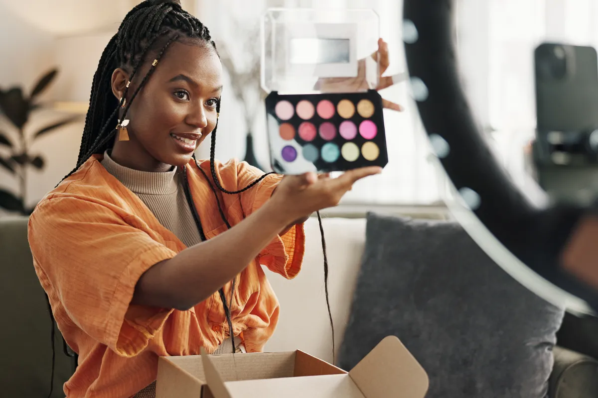 Content creator livestreaming products online, showing how becoming a full-time artist can involve digital entrepreneurship and diversified revenue streams.
