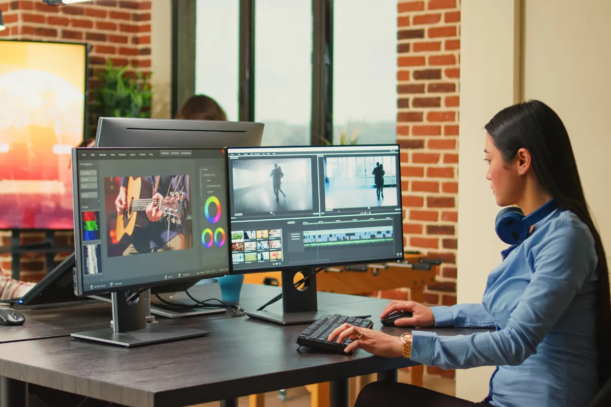 Creative professionals editing digital content in a studio, illustrating the journey of becoming a full-time artist through sustainable creative work and diversified income streams.
