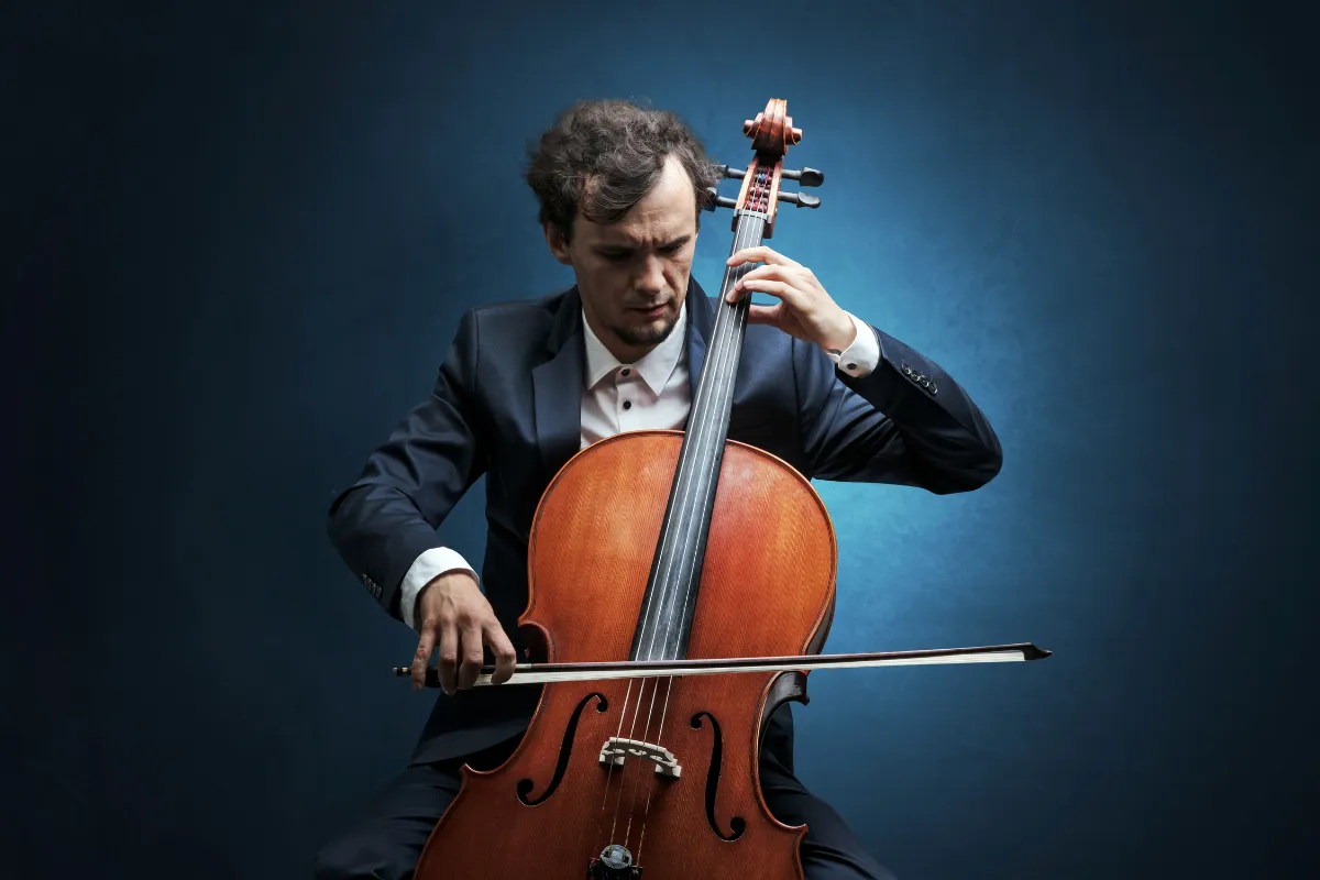 Professional musician performing on a cello, representing becoming a full-time artist through artistic dedication, skill development, and financial preparation.